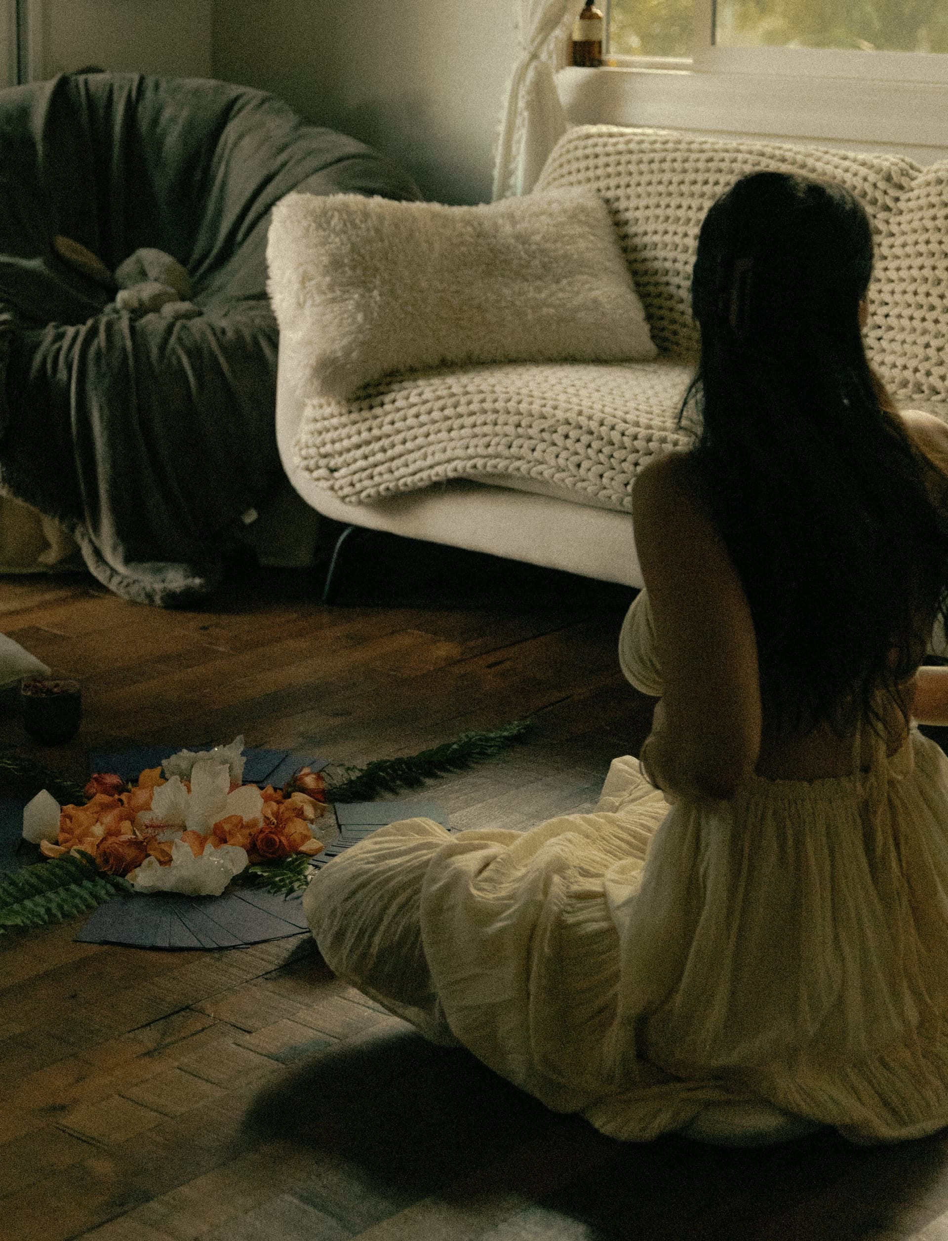 kenna and freya seated in ceremony around an altar of flowers and crystals